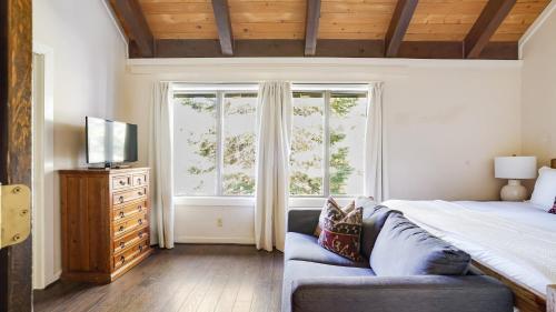 a bedroom with a bed and a large window at Marillac by AvantStay Gorgeous Ski Cabin w Balcony Patio in Olympic Valley