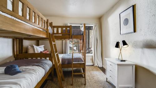 a bedroom with two bunk beds and a window at Marillac by AvantStay Gorgeous Ski Cabin w Balcony Patio in Olympic Valley