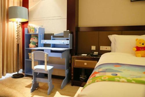 a bedroom with a bunk bed and a desk at Weida Hotel Jinhua in Jinhua