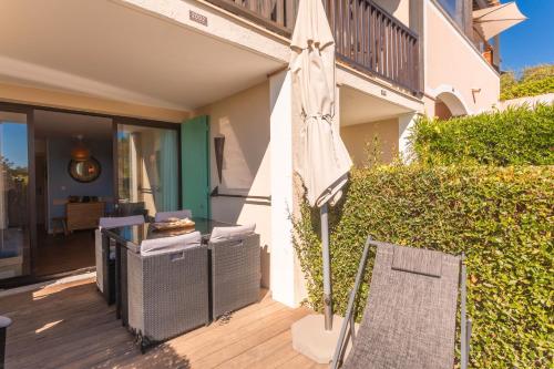 a closed umbrella sitting on a wooden deck at La Bohême in Grimaud