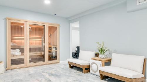 a living room with two chairs and a table at Game Farm Villa by AvantStay 10BDR Private Pond Spa Pool Family-Friendly in Catskill