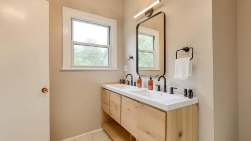 a bathroom with a sink and a mirror at Game Farm Villa by AvantStay 10BDR Private Pond Spa Pool Family-Friendly in Catskill