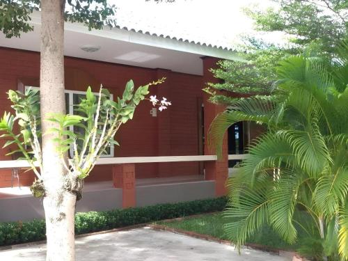 a red building with a tree in front of it at Lomdao Resort in Udon Thani