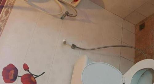 a bathroom with a toilet and a pipe on the wall at Lomdao Resort in Udon Thani