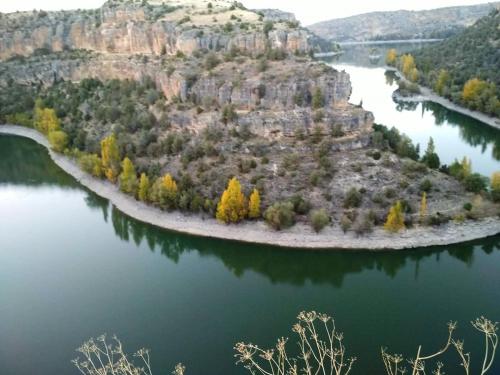 an island in the middle of a body of water at La Cerca Entre Hoces-10-20pax-Amplios espacios comunes in Sebúlcor