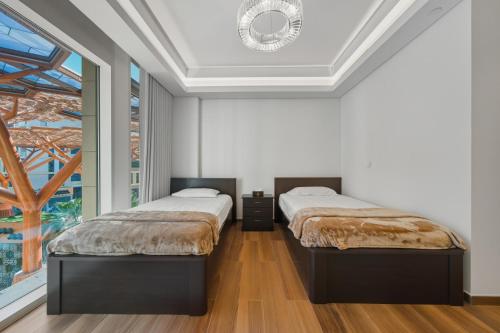 Ένα ή περισσότερα κρεβάτια σε δωμάτιο στο The Pearl Qatar Jewan Island