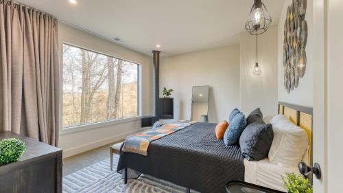 a bedroom with a bed and a large window at Dark Horse by AvantStay Secluded 5BDR w Hot Tub, Game Room, Deck Forest Views in Sevierville