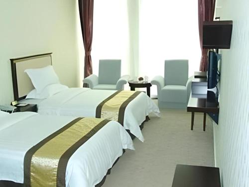 Cama o camas de una habitación en Sheng Lin Na Hotel Minzhi Branch
