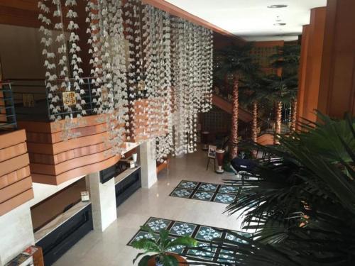 a lobby with a large wall of wine bottles at Labersa Grand Hotel &Convention Center in Pekanbaru