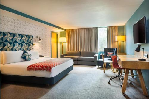 a hotel room with a bed and a desk at Hilton Bournemouth in Bournemouth