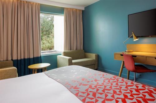 a hotel room with a bed and a desk at Hilton Bournemouth in Bournemouth