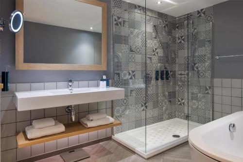 a bathroom with a sink and a shower at Hilton Bournemouth in Bournemouth