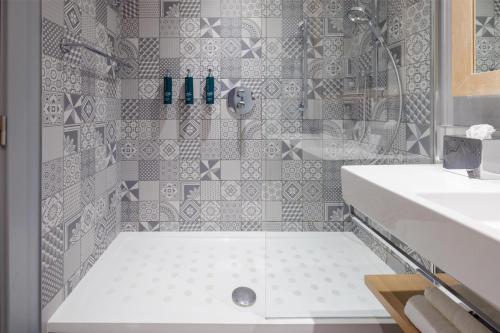 a bathroom with a shower and a white sink at Hilton Bournemouth in Bournemouth