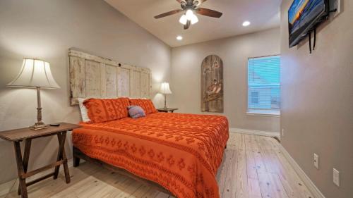 a bedroom with a bed and a ceiling fan at Pool Access Boat Dock Steps to the Gulf The Pintail by AvantStay in Padre Island