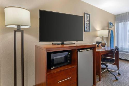 a hotel room with a television on a desk with a chair at Comfort Inn Wichita Falls North in Wichita Falls