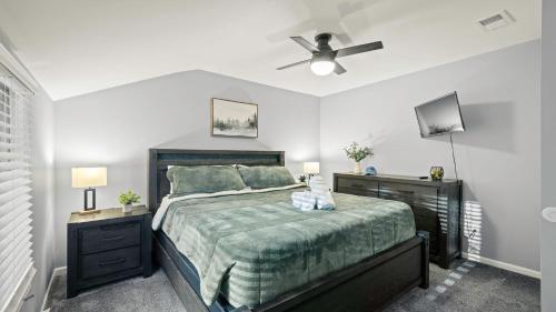 a bedroom with a bed and a ceiling fan at Lakeside Haven Ping Pong Fire Pit Mins to Big Boulder Lake Harmony in Lake Harmony