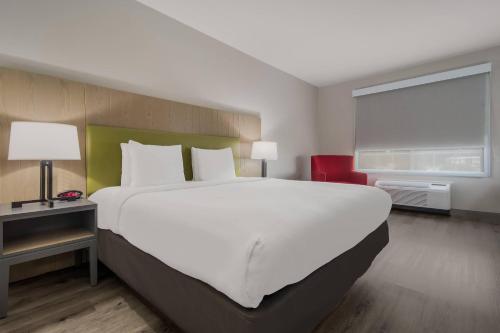 a bedroom with a large white bed and a window at Country Inn & Suites by Radisson, Goldsboro, NC in Goldsboro