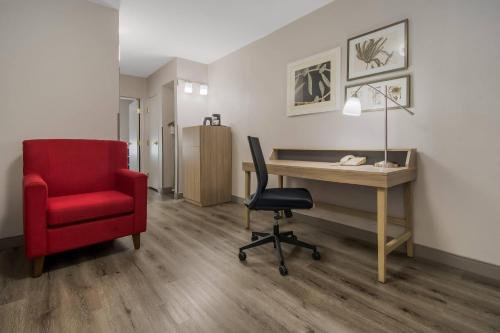 an office with a red chair and a desk at Country Inn & Suites by Radisson, Goldsboro, NC in Goldsboro