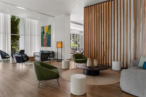 a living room with a couch and chairs and a table at Homewood Suites By Hilton Cariari San Jose in San José