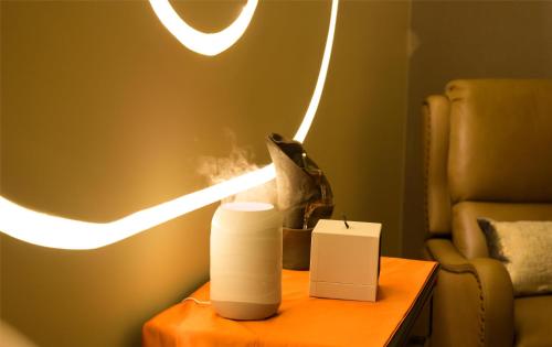 a table with a candle and a light on it at Blossom Hotel Houston, Curio Collection by Hilton in Houston