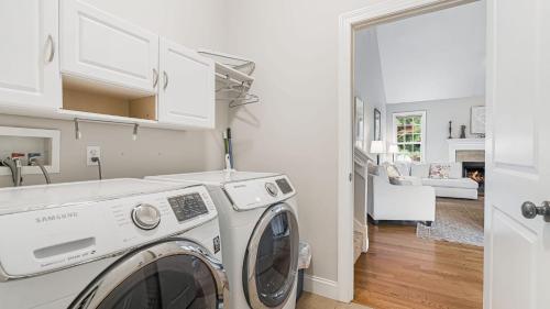 a white laundry room with a washer and dryer at Fairview Vista by AvantStay 10 Mins to Asheville in Fairview