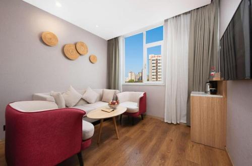 a living room with a couch and a table at New Beacon Sunyee SPA Hotel in Wuhan
