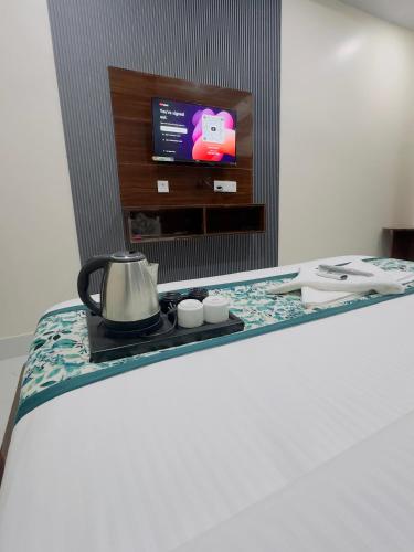 a tea kettle on a table in a room at Hotel Madhav inn in Mathura