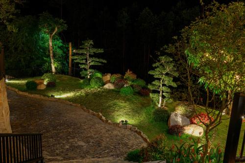 a garden at night with rocks and trees at Valley De Mango Hue in Thôn Châu Chữ