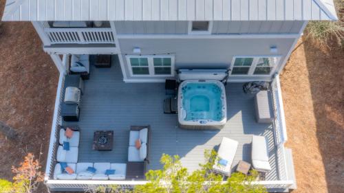 an aerial view of a house with a swimming pool at Coconut Cove by AvantStay Deck w Hot Tub Access to 2 Pools in Santa Rosa Beach