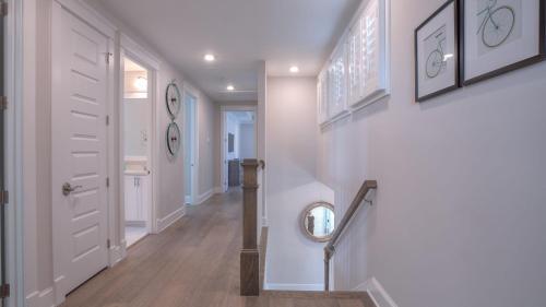 a hallway with a white door and a mirror at Coconut Cove by AvantStay Deck w Hot Tub Access to 2 Pools in Santa Rosa Beach