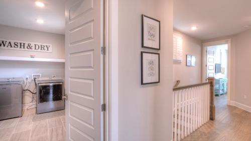 a white door in a kitchen with a washing machine at Coconut Cove by AvantStay Deck w Hot Tub Access to 2 Pools in Santa Rosa Beach