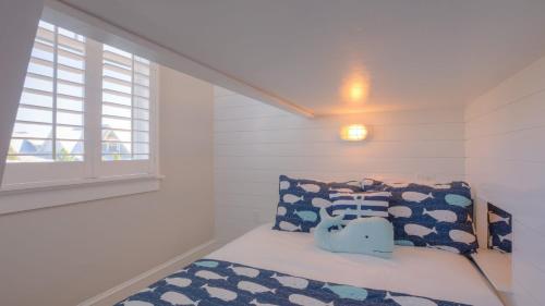 a small bedroom with a bed and a window at Coconut Cove by AvantStay Deck w Hot Tub Access to 2 Pools in Santa Rosa Beach