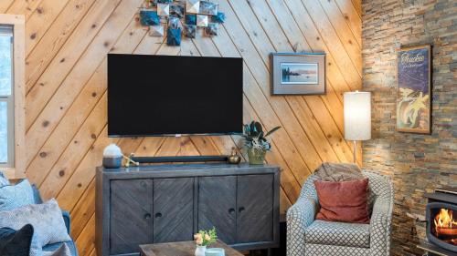 a living room with a television on a wooden wall at Jeffrey Pines Lofted Cabin Minutes to Lake A-Frame-Inspired Design Deck in Truckee