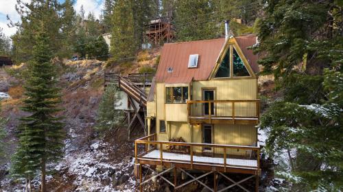 a house on the side of a mountain at Jeffrey Pines Lofted Cabin Minutes to Lake A-Frame-Inspired Design Deck in Truckee