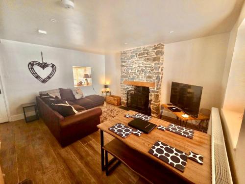 a living room with a couch and a fireplace at Characterful 2 bed within Conwy Walls in Conwy