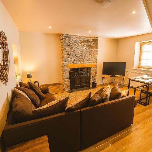 a living room with a couch and a fireplace at Characterful 2 bed within Conwy Walls in Conwy