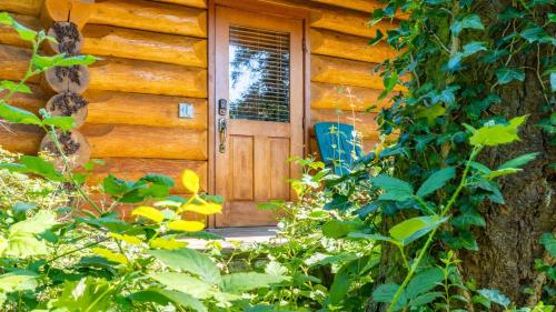 a wooden door of a log cabin at Penn Cove Overlook by AvantStay Cabin w Views in Oak Harbor