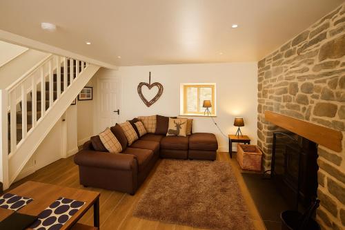 a living room with a couch and a fireplace at Characterful 2 bed within Conwy Walls in Conwy