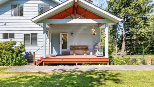 a porch with a bench on a house at Harborview Getaway by AvantStay Walk to Beach in Langley