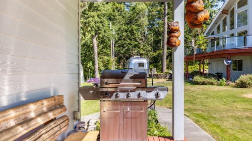 a barbecue grill sitting on the side of a house at Harborview Getaway by AvantStay Walk to Beach in Langley