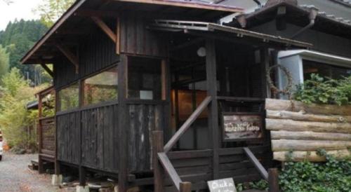 a large wooden cabin with a large window at Secret Base Tokinokakera in Yufuin