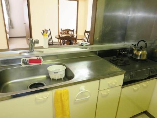 a kitchen counter with a sink and a stove at Frontier Sunrise in Kami-furano