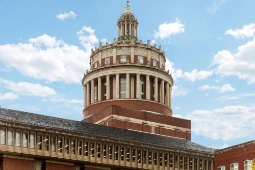 a building with a tower on top of a building at Baymont by Wyndham Henrietta - Rochester in Henrietta