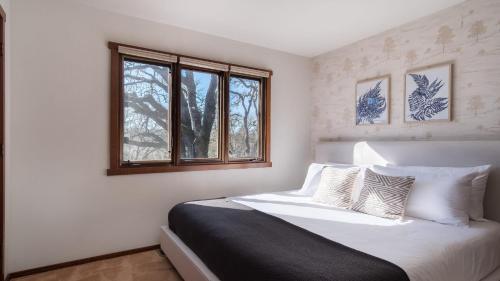 a bedroom with a white bed and a window at Gable by AvantStay Beautiful 3.5 Acre Oasis w Gorgeous Views Pool Hot Tub in Santa Rosa