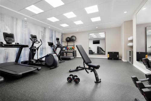 a gym with several treadmills and exercise bikes at Hilton Garden Inn New York - Times Square Central in New York