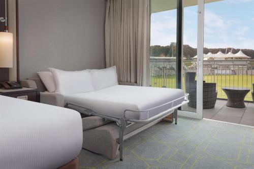 a hospital room with a bed and a couch at Hilton Southampton - Utilita Bowl in Southampton