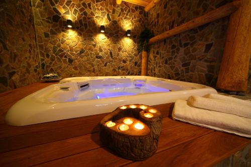 a bathroom with a tub with lights in it at Pod Ponco Apartments in Kranjska Gora