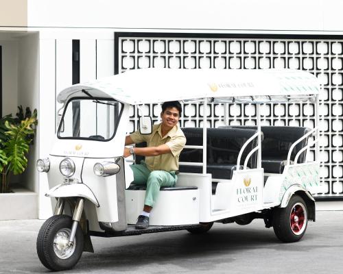 a man sitting in the back of a golf cart at Floral Court Hotel & Residence Sukhumvit 13 in Bangkok