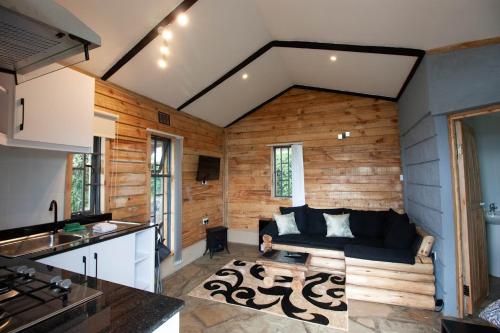 a kitchen and a living room with a couch at Couple's Wood Cabin in Naivasha - Elwai Visitor Centre in Naivasha