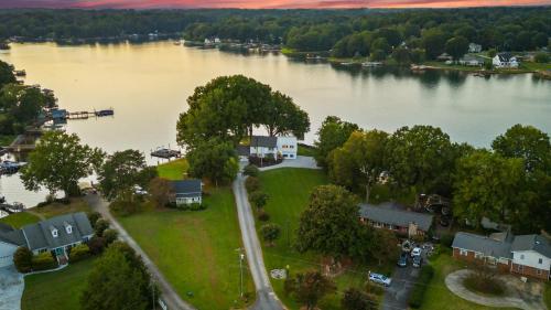 an aerial view of a house next to a river at Lakefront Home w Dock Game Room Hot Tub Ponderosa Peninsula by AvantStay in Mayhew